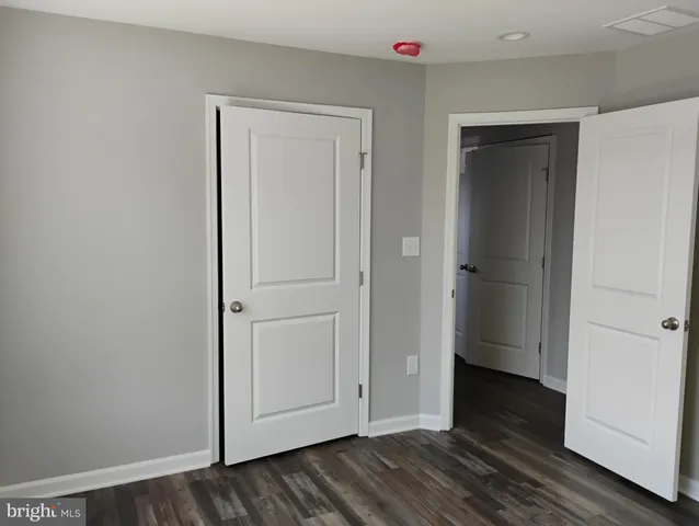 a view of hallway with wooden floor