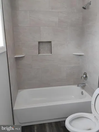 a bathroom with a bathtub and a toilet