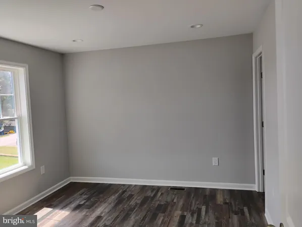 a view of wooden floor and chandelier fan in a room