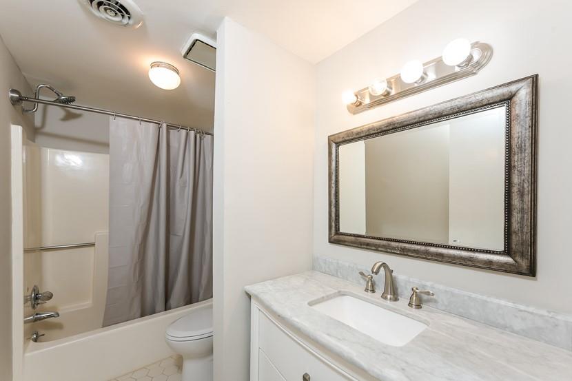 2505 West Broad Street, Unit 122 Athens, GA 30606 - Photo 14 of 15 a bathroom with a granite countertop sink toilet and shower