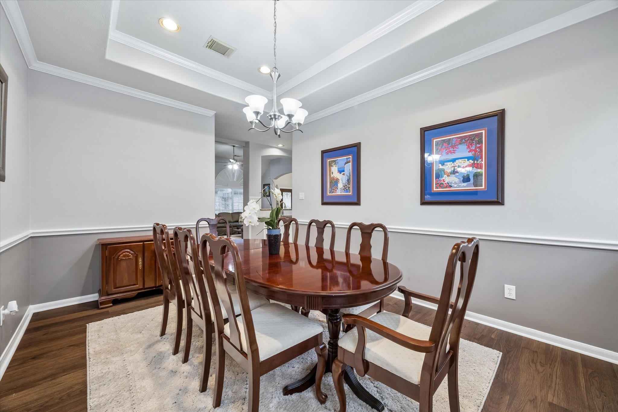 12423 Rutgers Park Court Houston, TX 77058 - Photo 9 of 29 a view of a dining room with furniture a chandelier and wooden floor