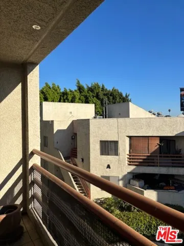 a view of balcony with two chairs and a table