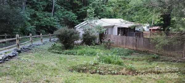 a view of a house with a yard and balcony