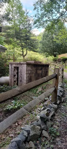 a view of a yard with wooden fence