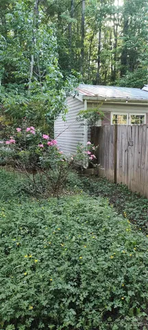 a backyard of a house with lots of green space and fountain