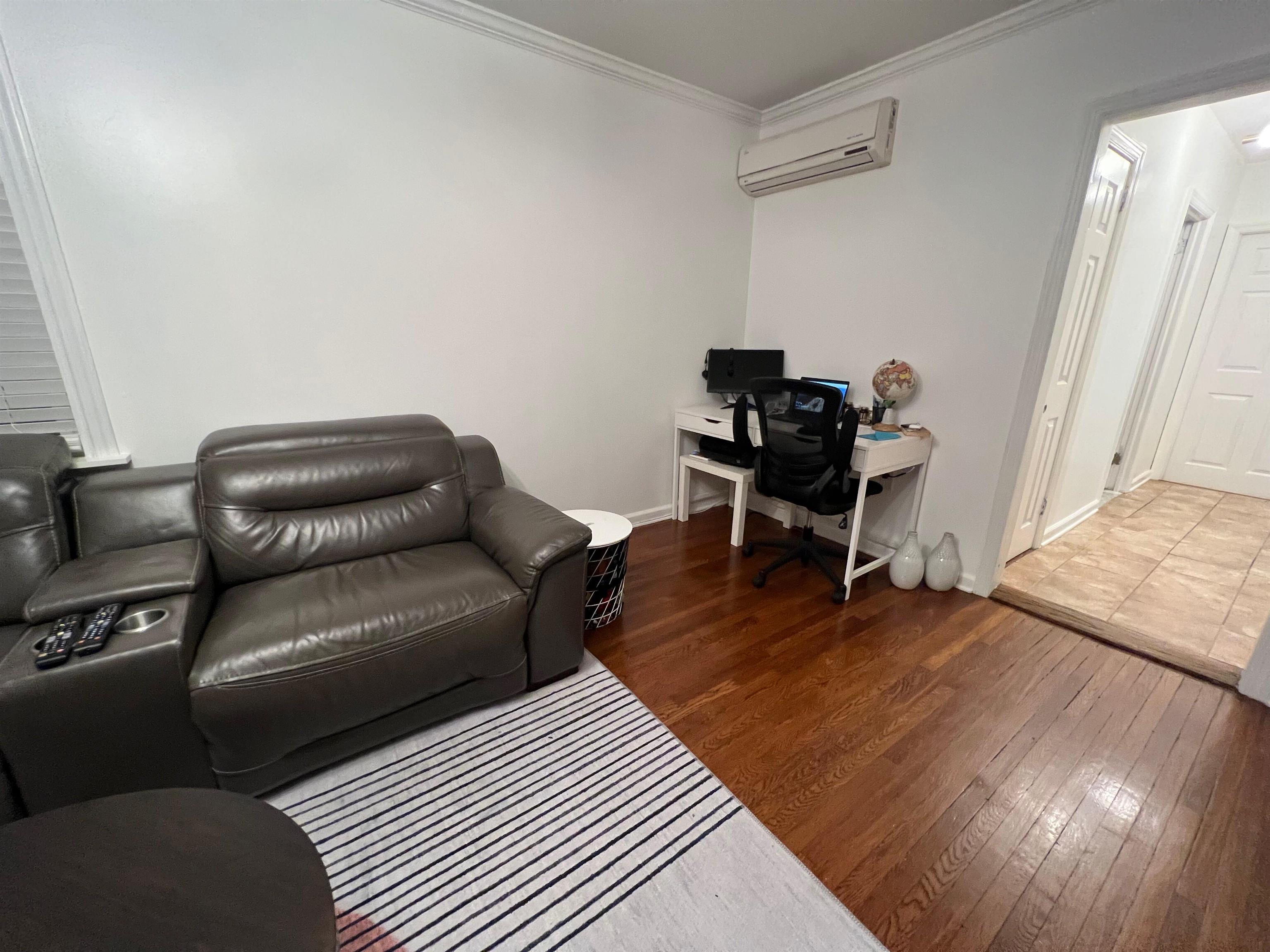 11 Beverly Place, Unit 1 Edgewater, NJ 07020 - Photo 11 of 18 a living room with furniture and a wooden floor