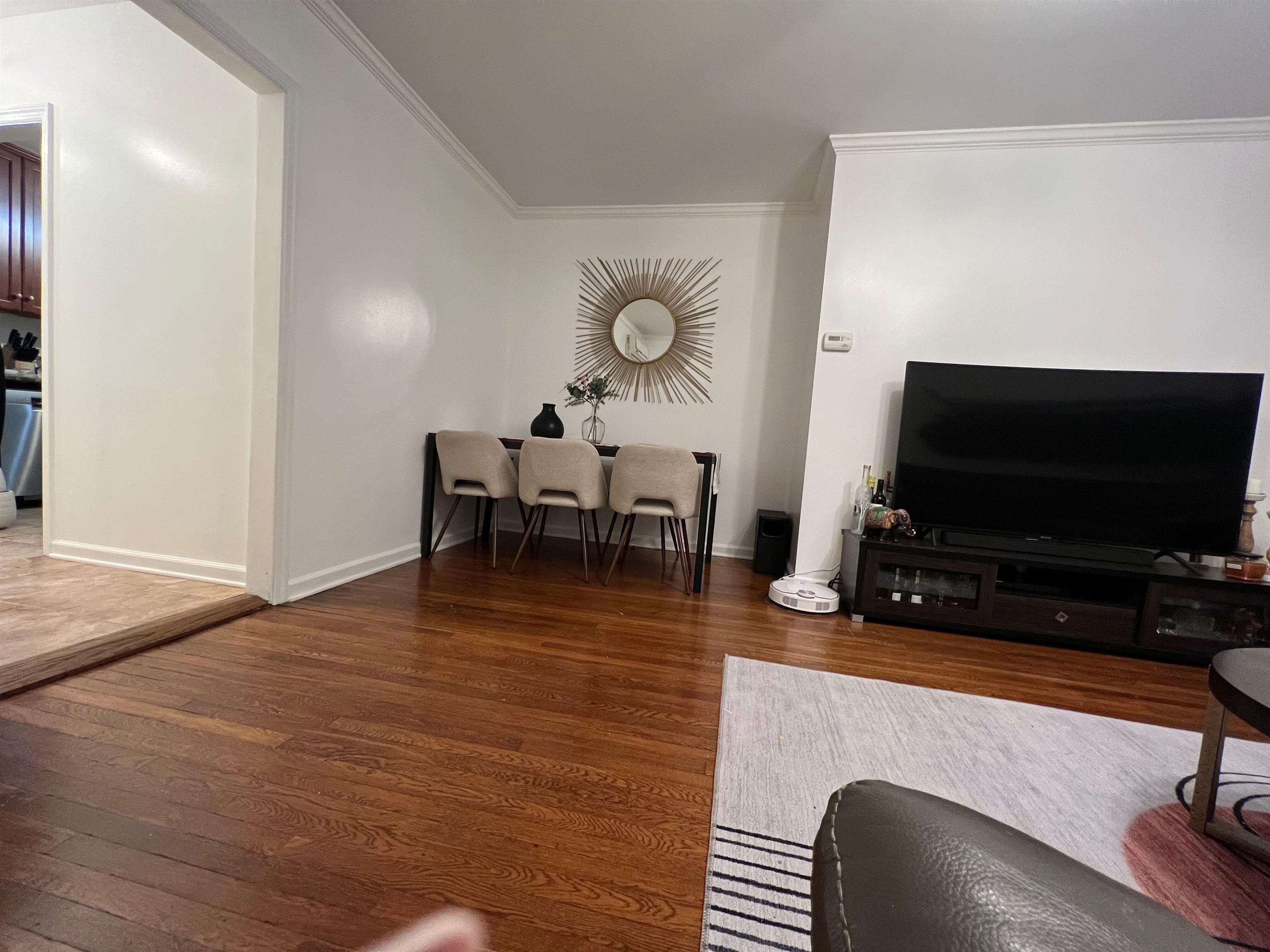 11 Beverly Place, Unit 1 Edgewater, NJ 07020 - Photo 12 of 18 a living room with furniture and a flat screen tv