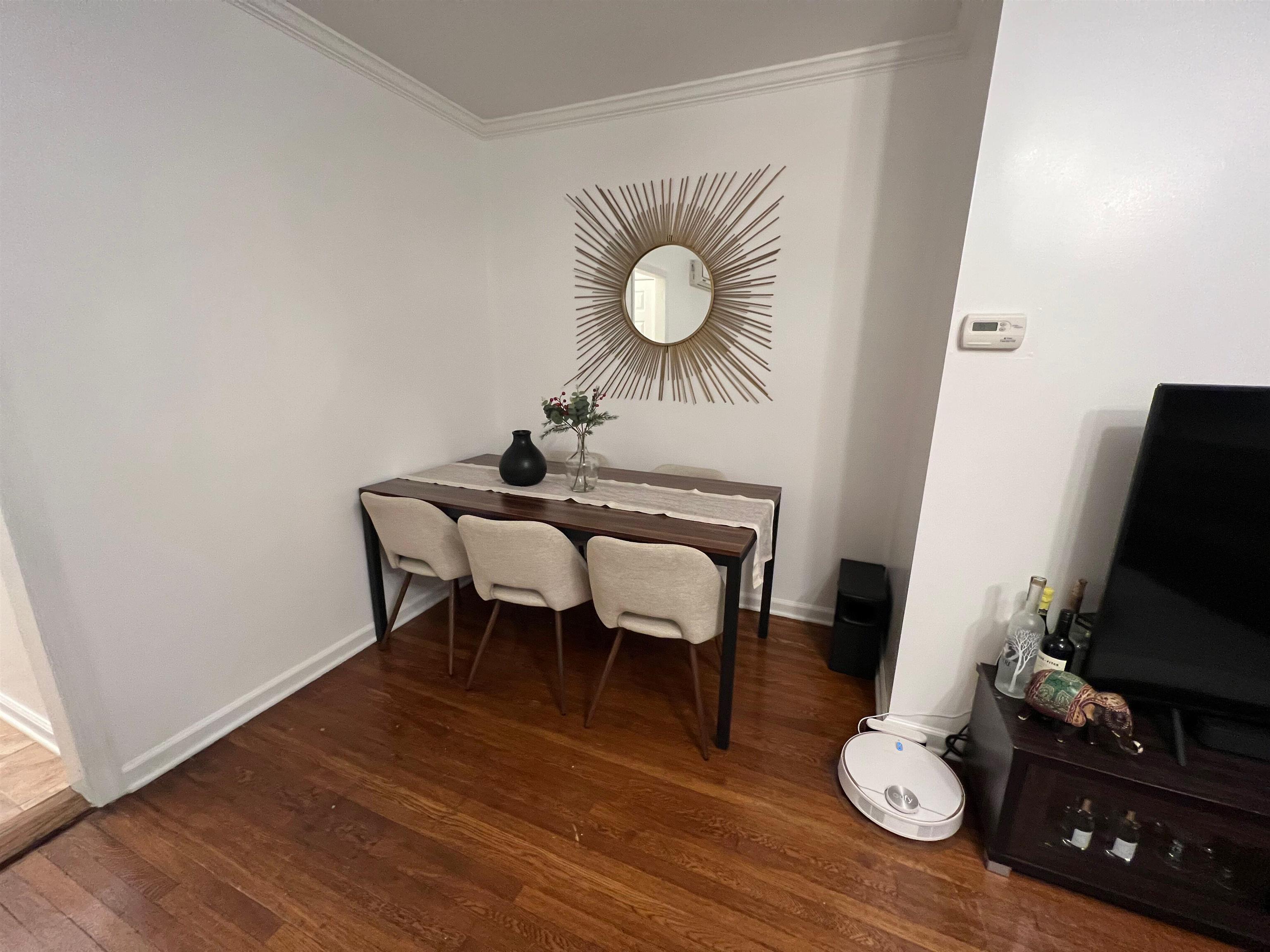 11 Beverly Place, Unit 1 Edgewater, NJ 07020 - Photo 13 of 18 a view of a dining room with furniture and wooden floor