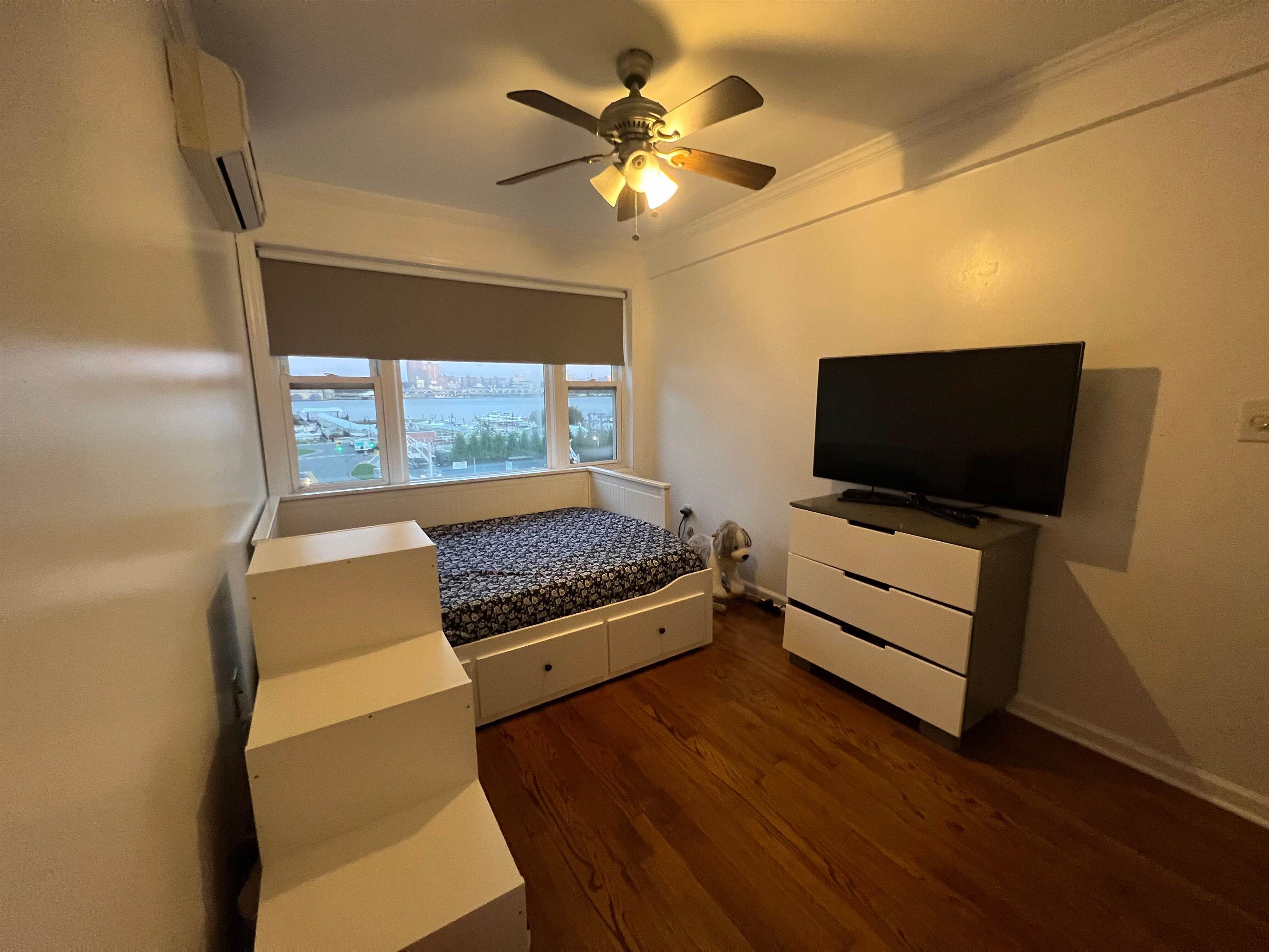11 Beverly Place, Unit 1 Edgewater, NJ 07020 - Photo 15 of 18 a living room with furniture and a flat screen tv