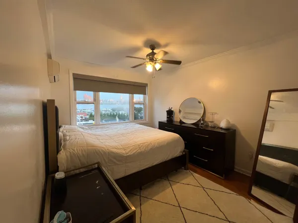 a bedroom with a bed and a mirror