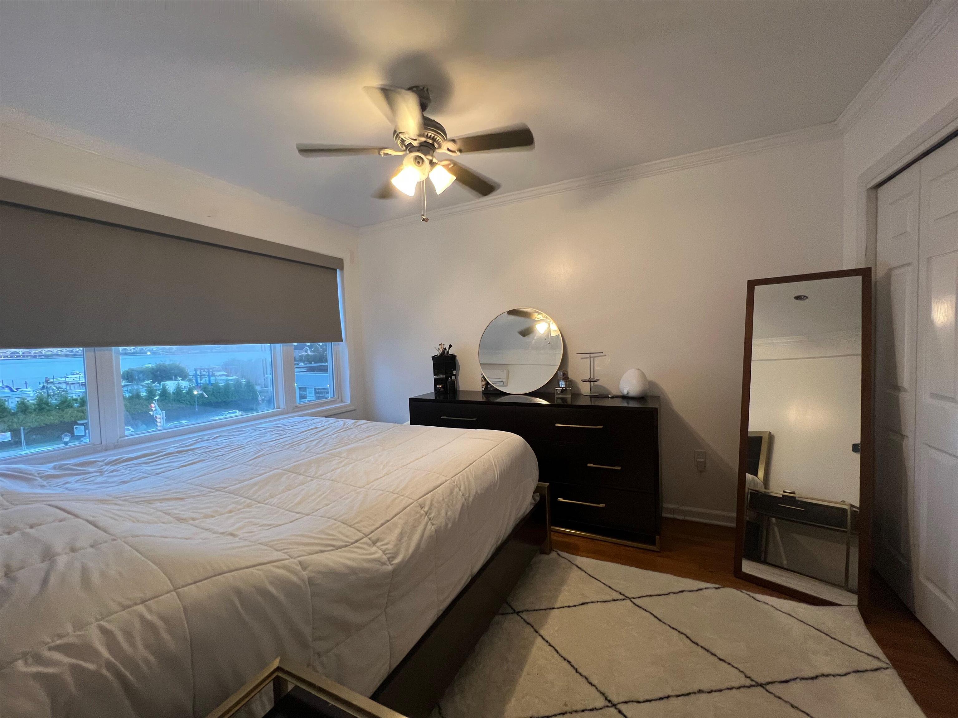 11 Beverly Place, Unit 1 Edgewater, NJ 07020 - Photo 5 of 18 a bedroom with a bed and wooden floor