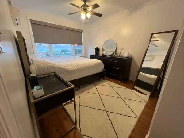 a bedroom with a bed and a mirror
