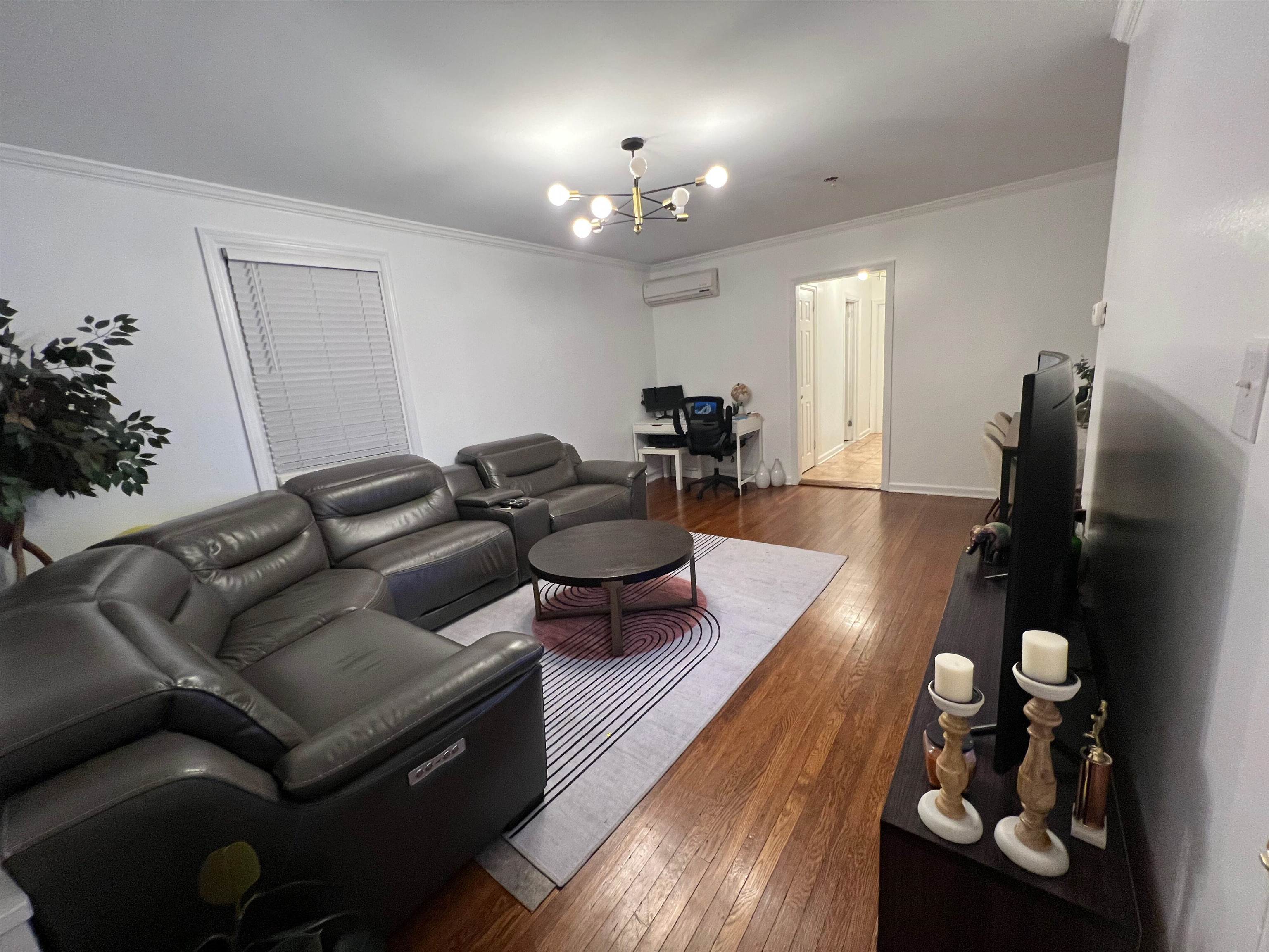 11 Beverly Place, Unit 1 Edgewater, NJ 07020 - Photo 9 of 18 a living room with furniture and wooden floor