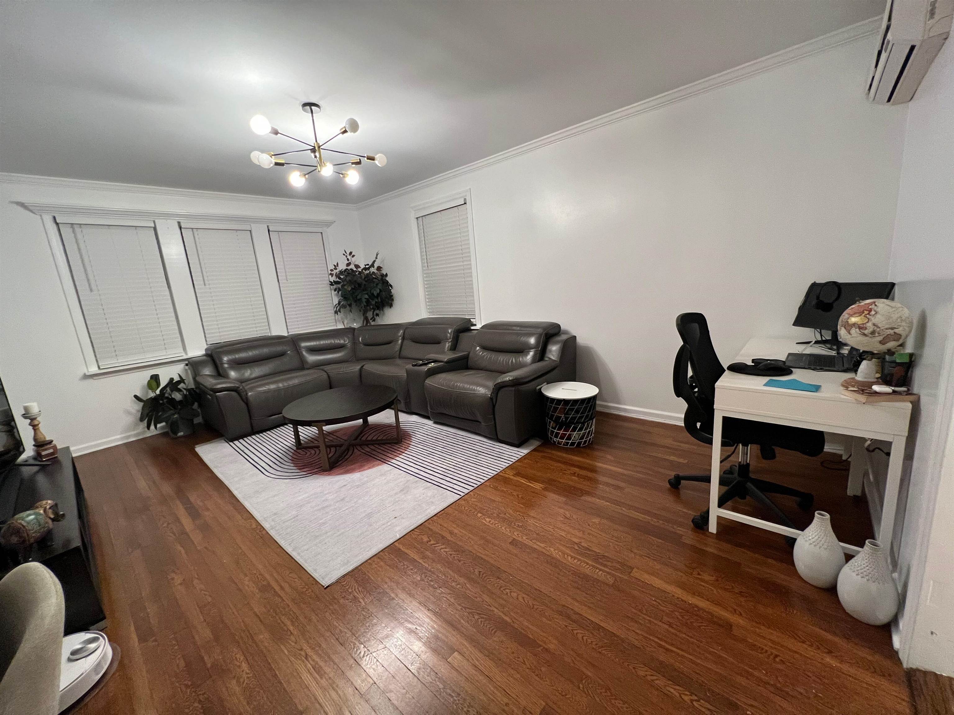 11 Beverly Place, Unit 1 Edgewater, NJ 07020 - Photo 10 of 18 a living room with furniture and a wooden floor