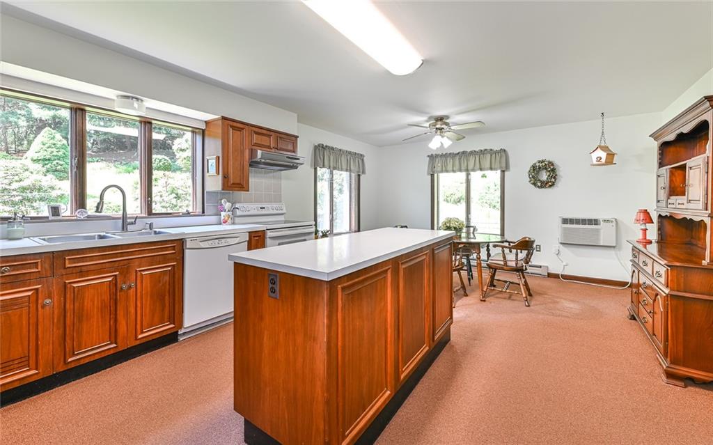 2371 Oakview Drive Pittsburgh, PA 15237 - Photo 13 of 25 a kitchen with stainless steel appliances granite countertop sink stove and wooden cabinets
