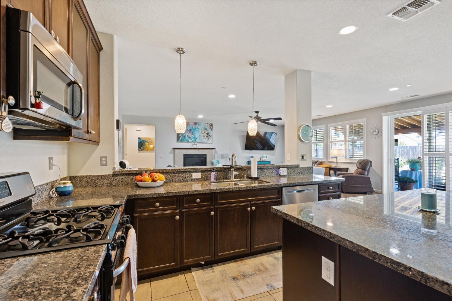 2011 Roy Ranch Way Plumas Lake, CA 95961 - Photo 40 of 49 a kitchen with granite countertop a sink stove and cabinets