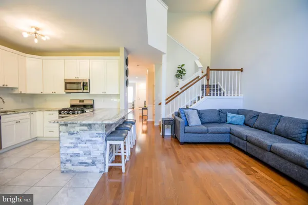 a kitchen with stainless steel appliances granite countertop a stove and white cabinets