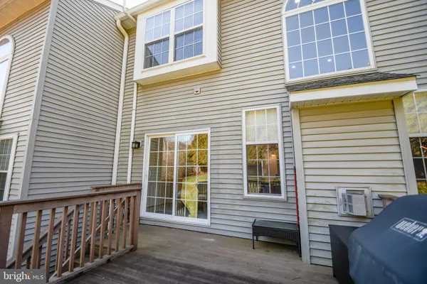 a view of a chairs and table on the wooden deck with a swimming pool