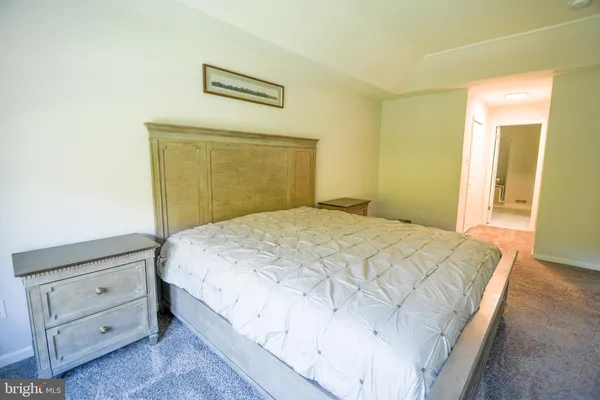 a bedroom with a bed and a flat screen television