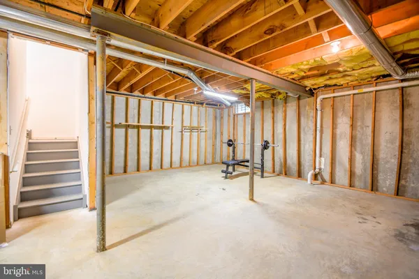 a view of a room with wooden walls and stairs