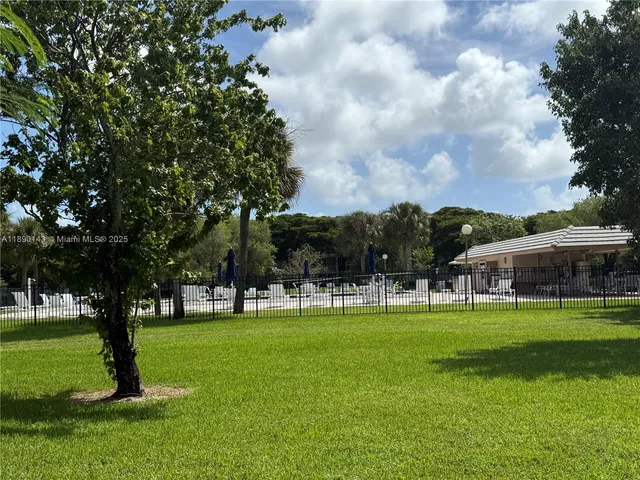 a huge green field with lots of trees
