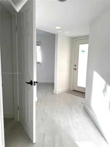 a view of an empty room with closet and a window