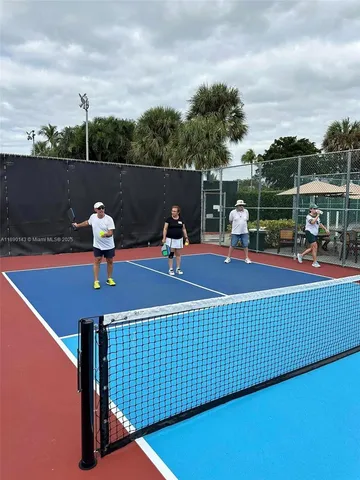 an aerial view of a swimming pool with outdoor seating