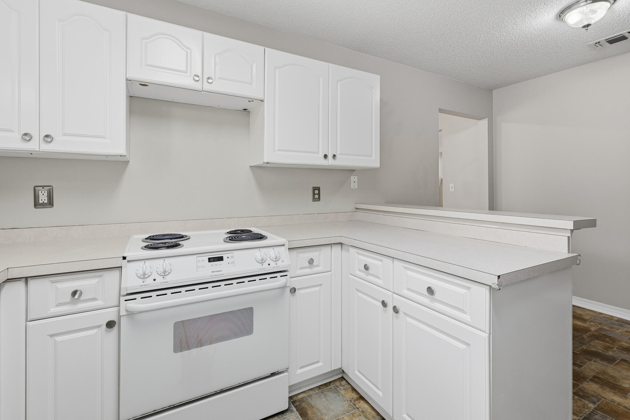 643 Alysheba Drive Crestview, FL 32539 - Photo 13 of 36 a kitchen with white cabinets and white appliances