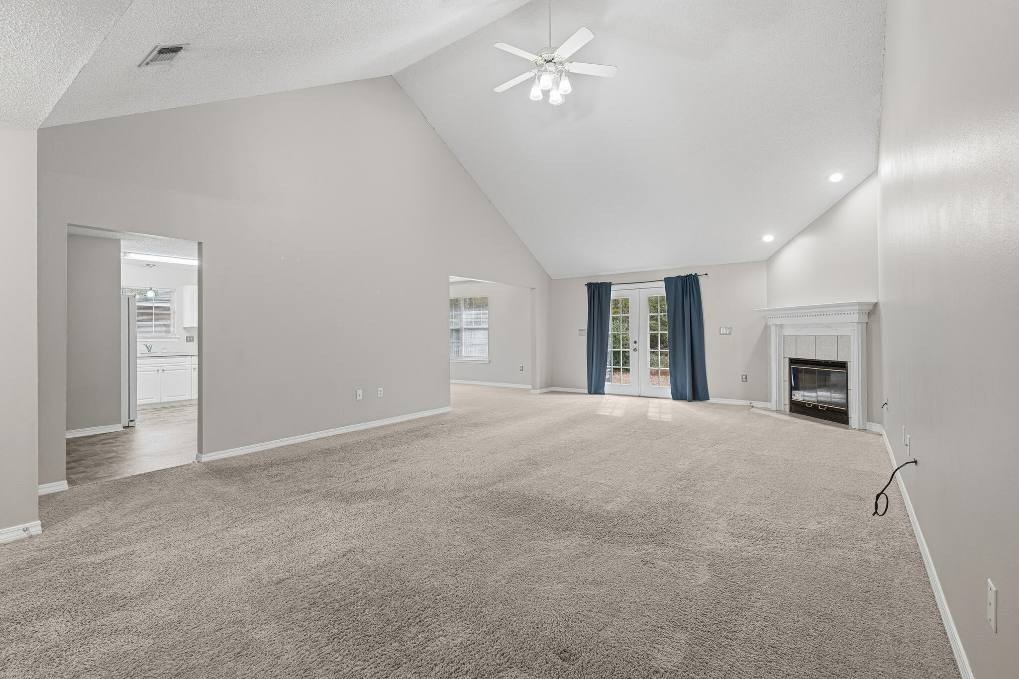 643 Alysheba Drive Crestview, FL 32539 - Photo 8 of 36 an empty room with windows and fireplace