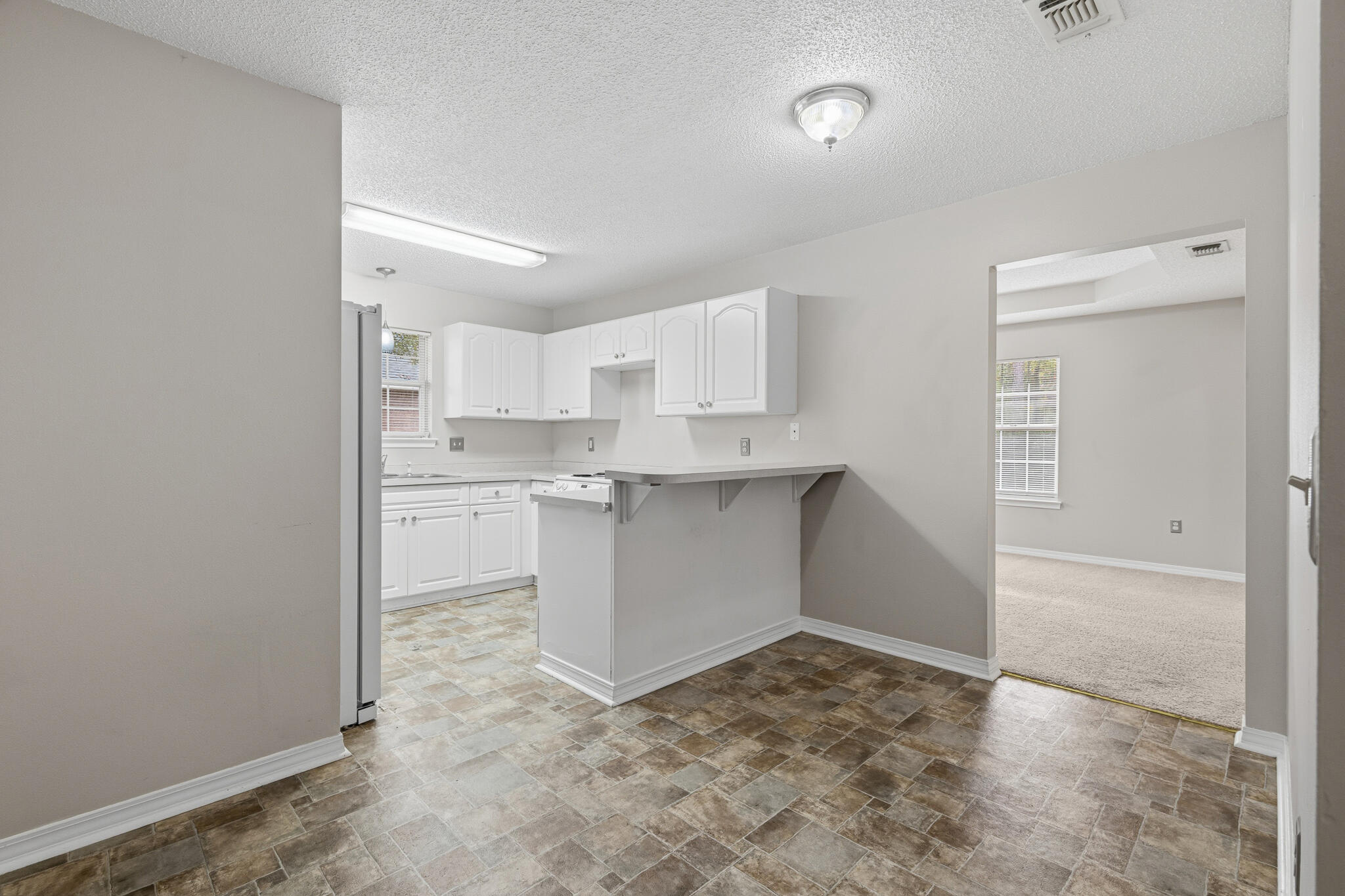 643 Alysheba Drive Crestview, FL 32539 - Photo 9 of 36 a room with a cabinets and window