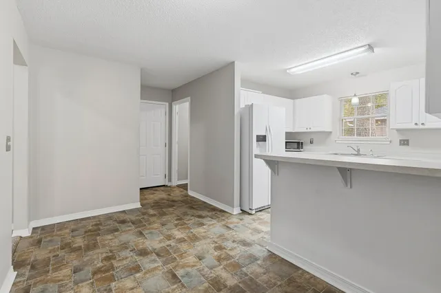 a kitchen with stainless steel appliances a sink and a refrigerator