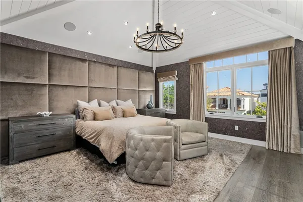 a bedroom with a bed and a chandelier