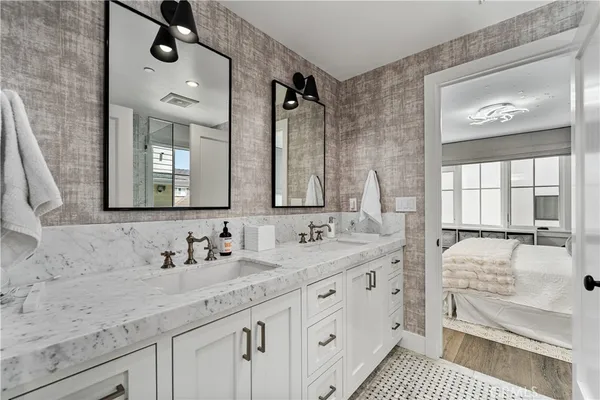 a bathroom with a double vanity sink and mirror