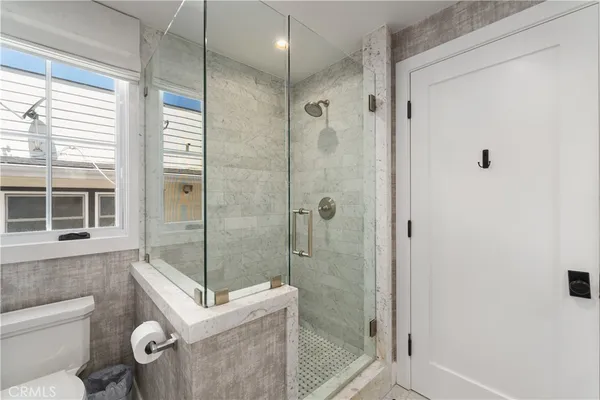 a spacious bedroom with a bed and a view of bathroom