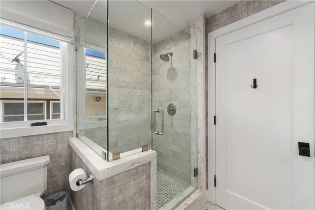 a spacious bedroom with a bed and a view of bathroom