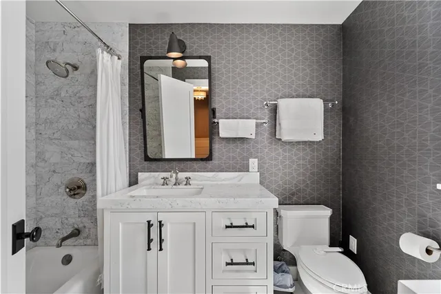 a bathroom with a sink a mirror and a shower