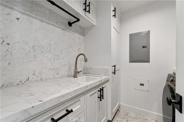 a view of a patio with table and chairs under an umbrella with a small yard