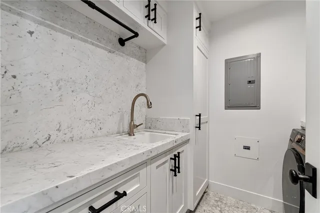a view of a patio with table and chairs under an umbrella with a small yard