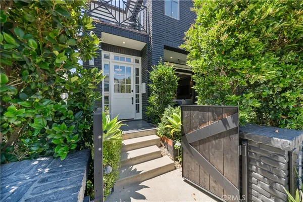 a balcony with furniture and a potted plant