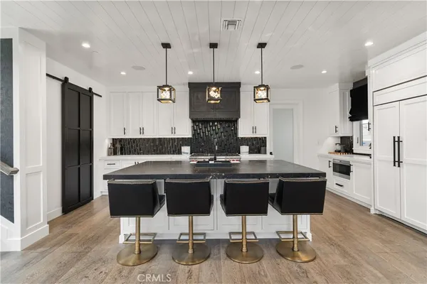 a kitchen with a sink cabinets and wooden floor