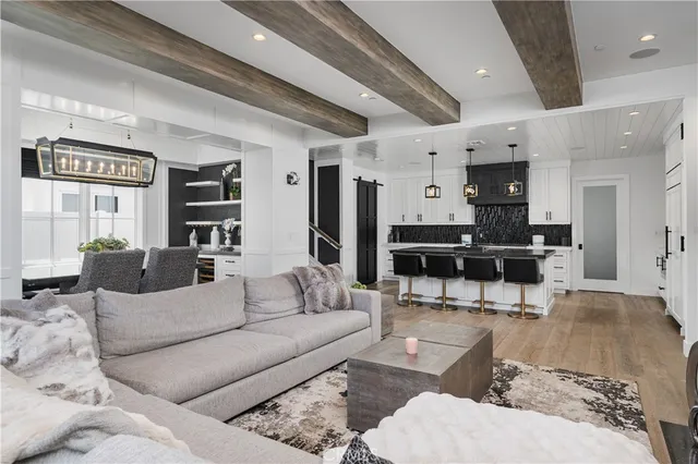 a living room with furniture and kitchen view