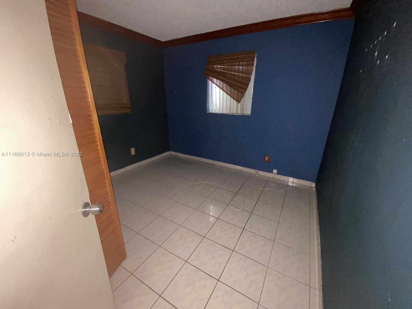 11755 Southwest 37th Street Miami, FL 33175 - Photo 11 of 11 an empty room with windows