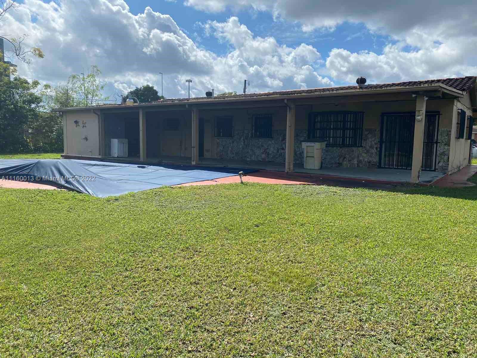 11755 Southwest 37th Street Miami, FL 33175 - Photo 3 of 11 a view of a house with a yard and a tree
