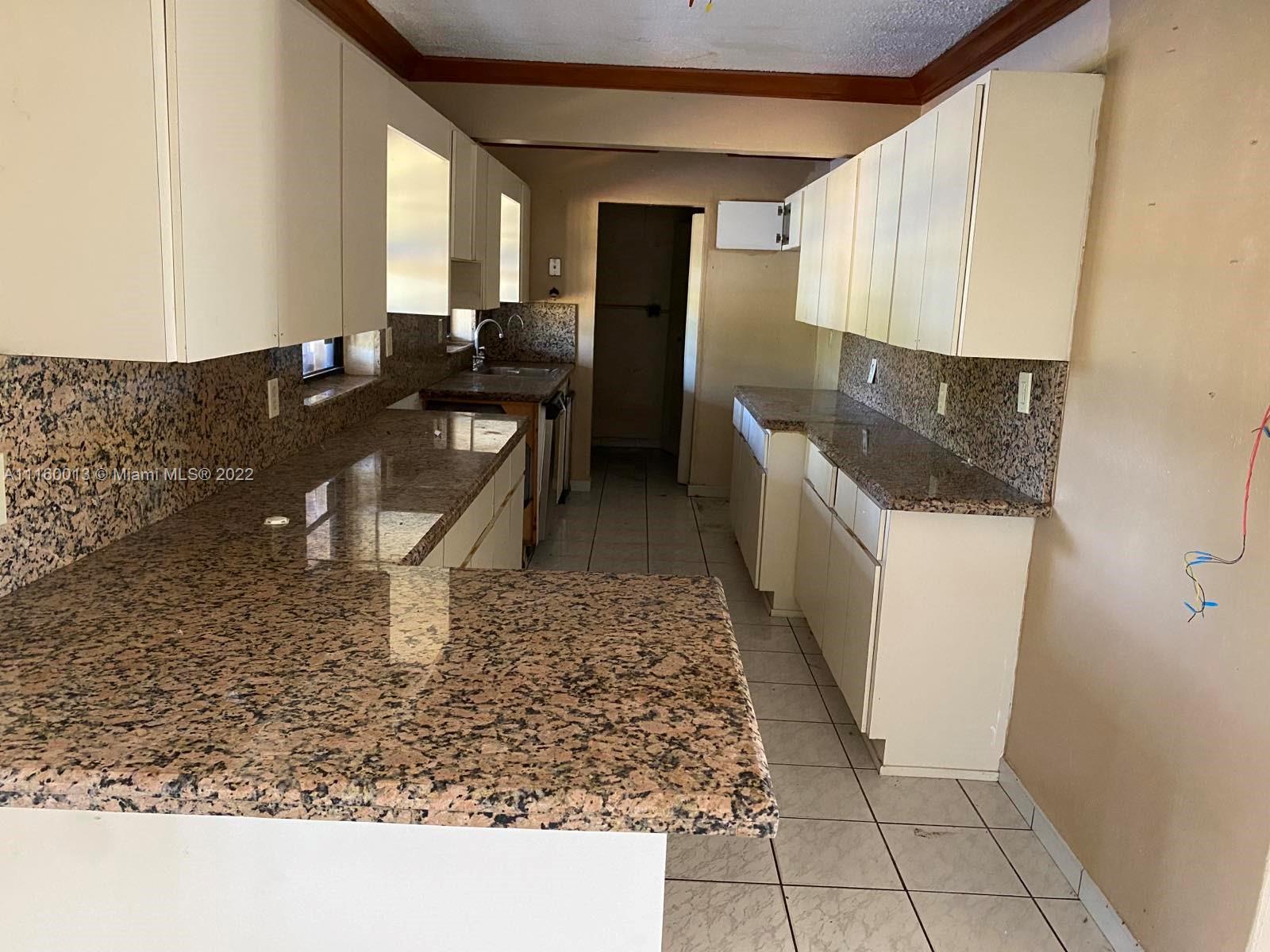 11755 Southwest 37th Street Miami, FL 33175 - Photo 6 of 11 a bathroom with a sink a toilet and mirror