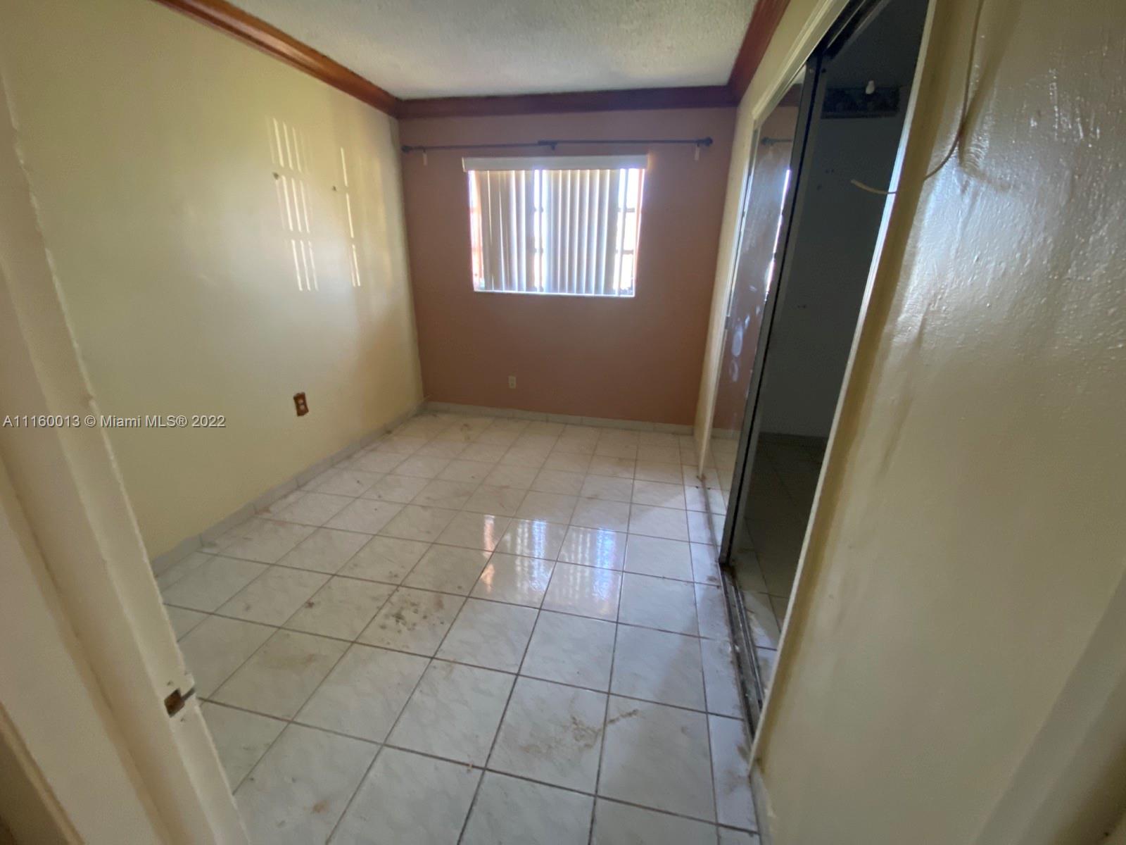 11755 Southwest 37th Street Miami, FL 33175 - Photo 9 of 11 a view of an empty room and a window