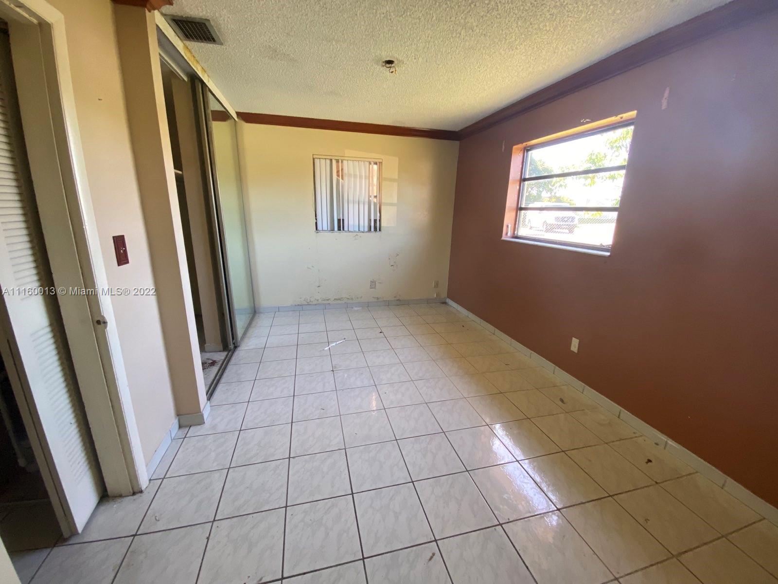 11755 Southwest 37th Street Miami, FL 33175 - Photo 10 of 11 a view of an empty room and window