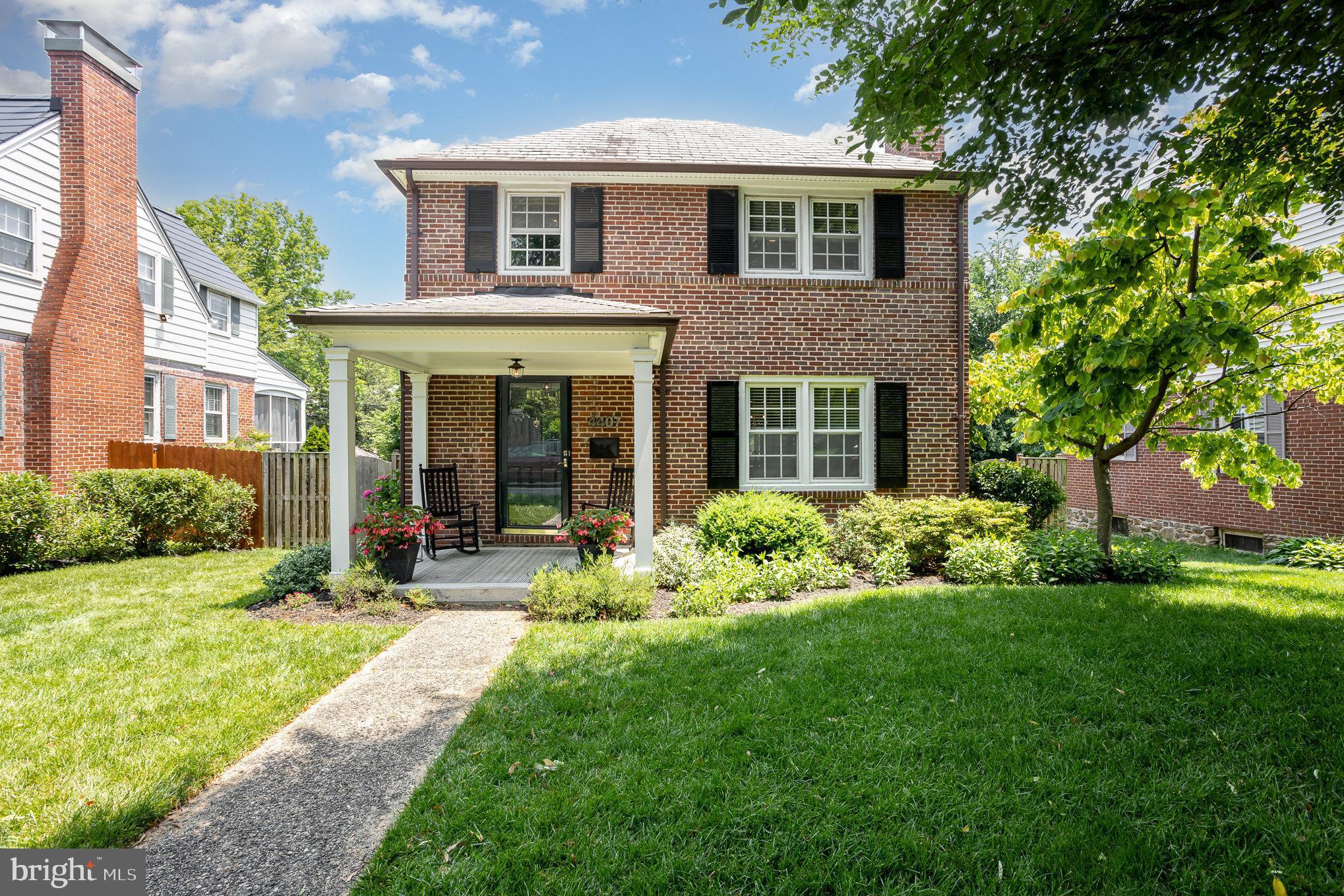 a front view of a house with a yard and porch
