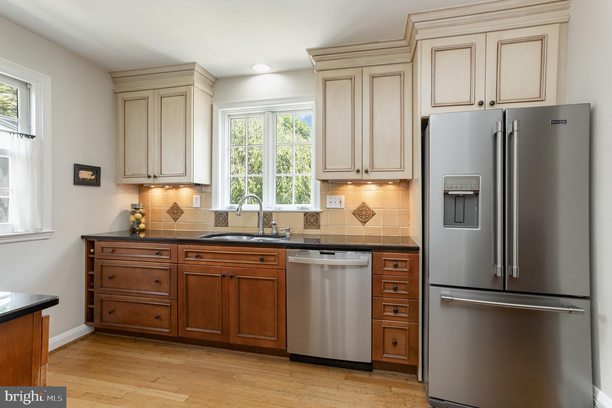 4407 Sedgwick Road Baltimore, MD 21210 - Photo 12 of 42 a kitchen with stainless steel appliances granite countertop a refrigerator sink and cabinets