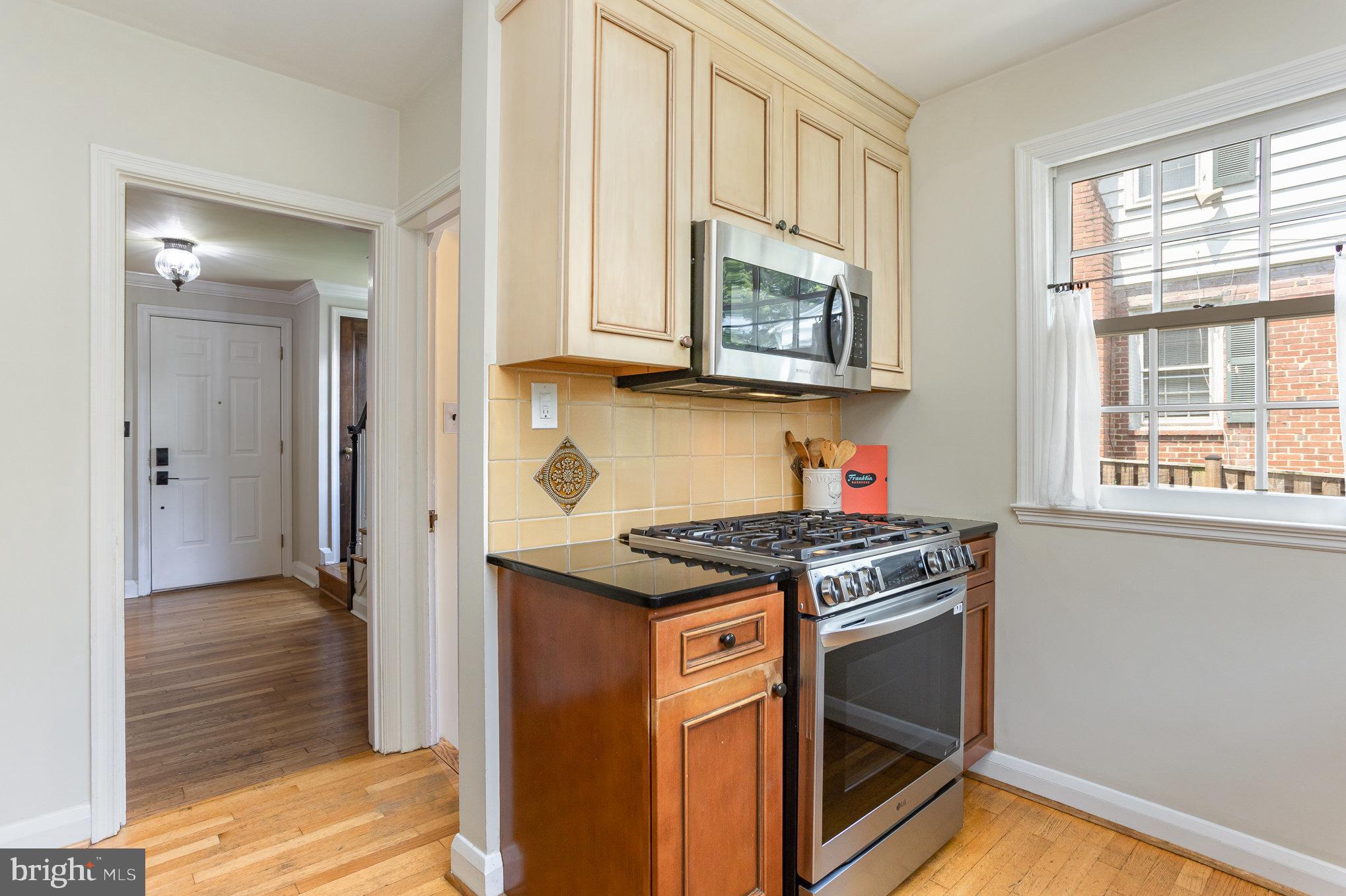 4407 Sedgwick Road Baltimore, MD 21210 - Photo 13 of 42 a kitchen with stainless steel appliances granite countertop a stove and a microwave