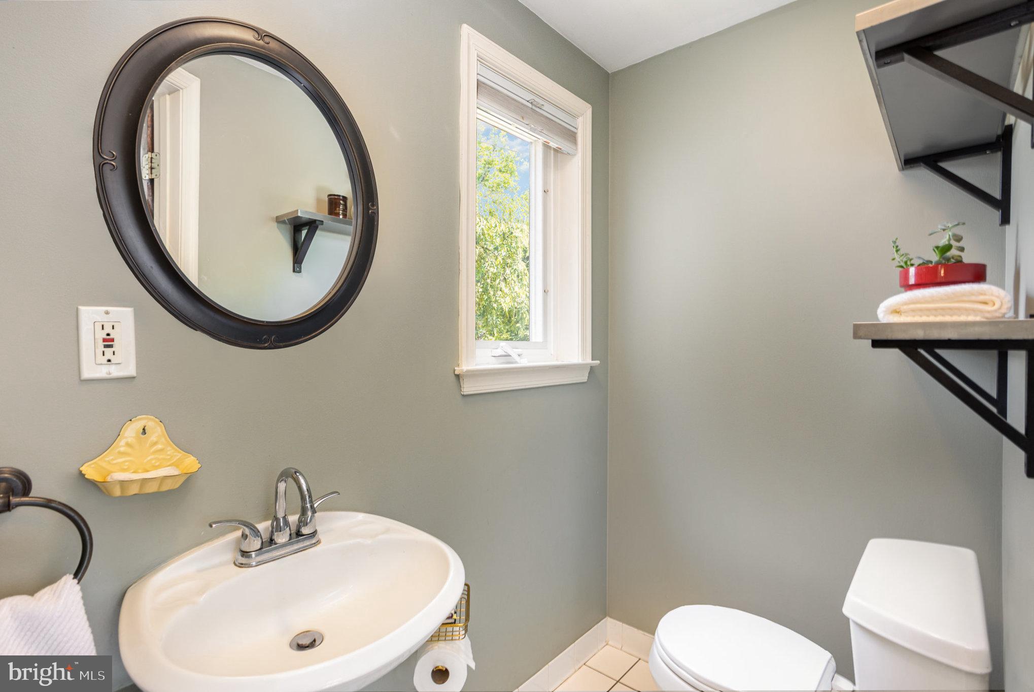 4407 Sedgwick Road Baltimore, MD 21210 - Photo 16 of 42 a bathroom with a toilet a sink and a mirror